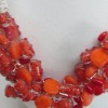 Orange and a splash of red.  Beads up close.